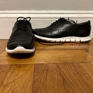 Zerogrand Cole Haan sneaker. Black leather with perforated brogue accents.